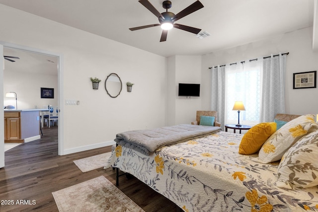 bedroom with ceiling fan and dark wood-type flooring