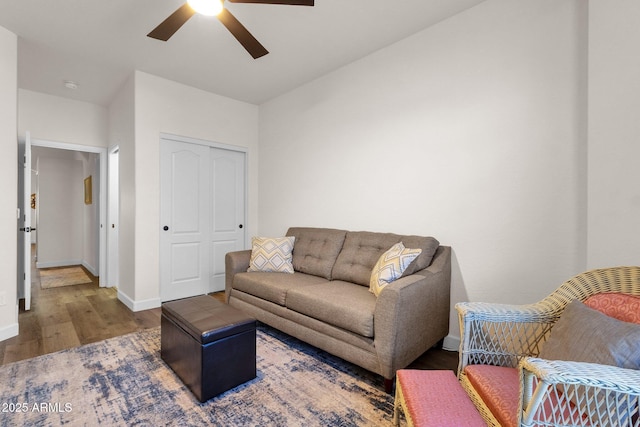 living room featuring hardwood / wood-style floors and ceiling fan