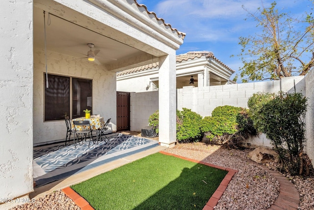 view of yard featuring a patio area and ceiling fan