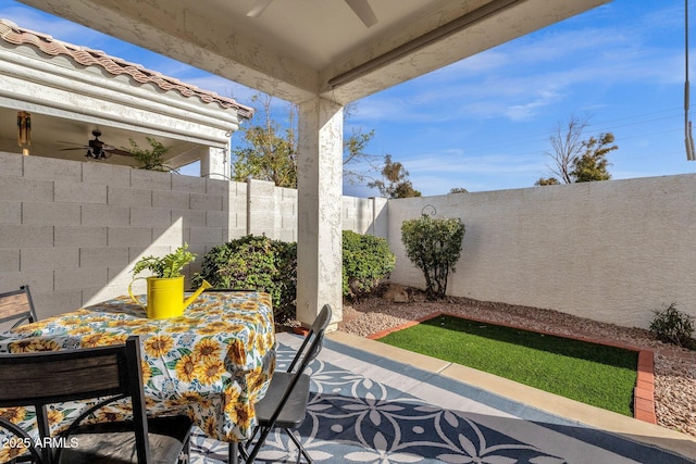 view of patio featuring ceiling fan