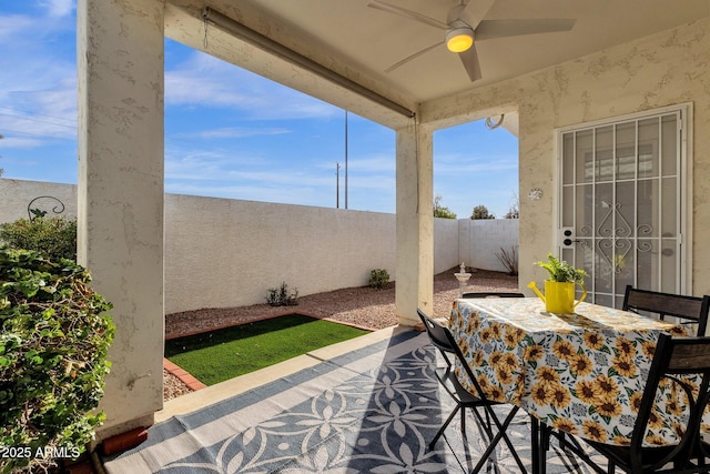 view of patio featuring ceiling fan