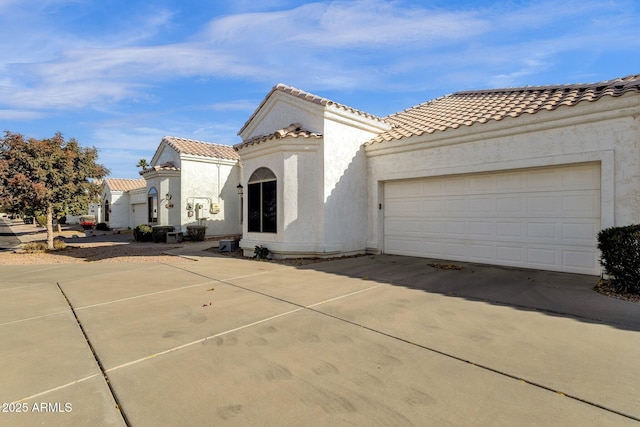 mediterranean / spanish house with a garage