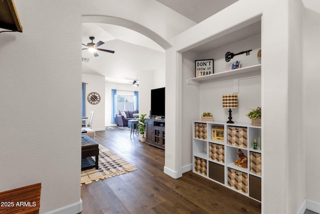 hall with dark hardwood / wood-style flooring and vaulted ceiling