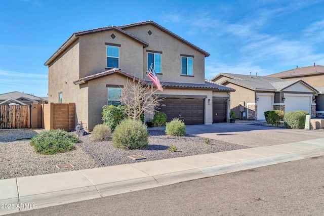 traditional home with stucco siding, fence, a garage, driveway, and a tiled roof