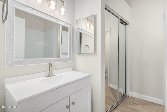 bathroom with vanity and hardwood / wood-style floors