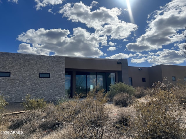 back of house with stucco siding