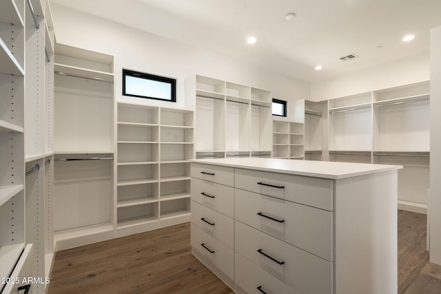 walk in closet featuring visible vents and dark wood-style floors