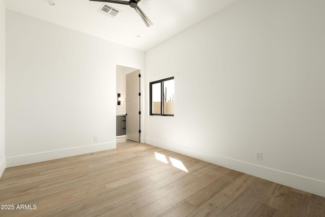 spare room featuring light wood-type flooring, baseboards, visible vents, and ceiling fan