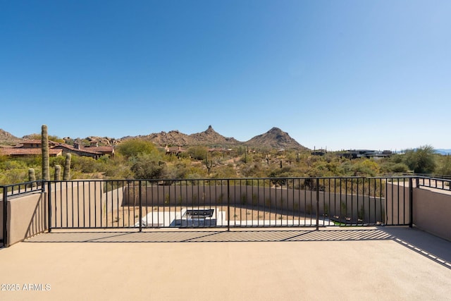 view of patio / terrace featuring a balcony and a mountain view