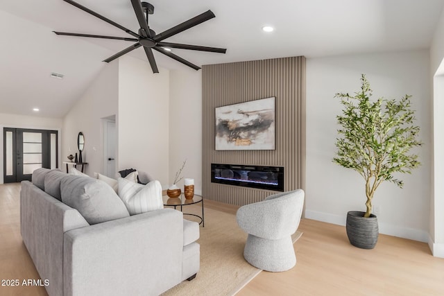 4532 E Sandra Ter, Phoenix, AZ 85032 - living room with wood finished floors, ceiling fan, recessed lighting, a glass covered fireplace, and vaulted ceiling
