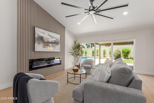 4532 E Sandra Ter, Phoenix, AZ 85032 - living room featuring vaulted ceiling, a glass covered fireplace, wood finished floors, and recessed lighting