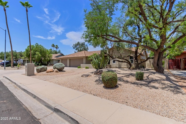 4532 E Sandra Ter, Phoenix, AZ 85032 - view of front facade with a garage, stucco siding, and driveway
