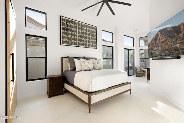 bedroom featuring a high ceiling and ceiling fan