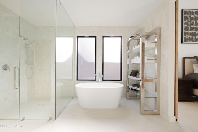 bathroom with tile patterned flooring and independent shower and bath