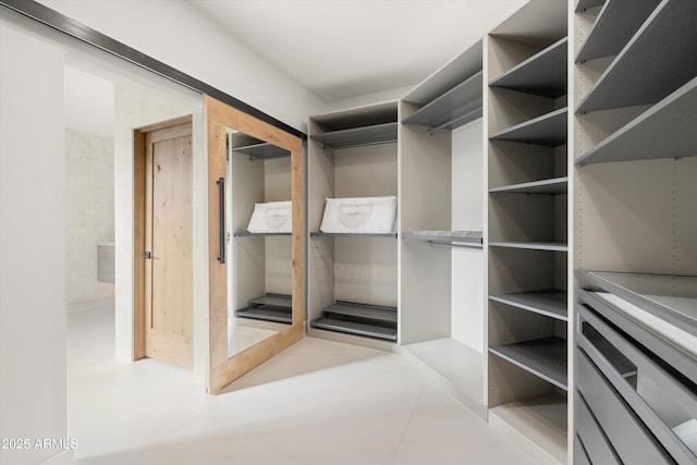 spacious closet with light tile patterned floors