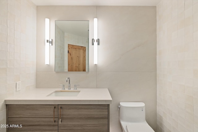 bathroom with tile walls, vanity, tasteful backsplash, and toilet