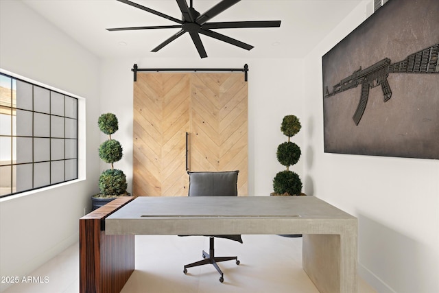 office area with a barn door and ceiling fan