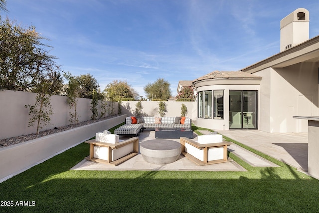 view of patio featuring an outdoor living space with a fire pit and a sunroom