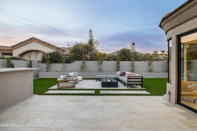 patio terrace at dusk featuring an outdoor hangout area