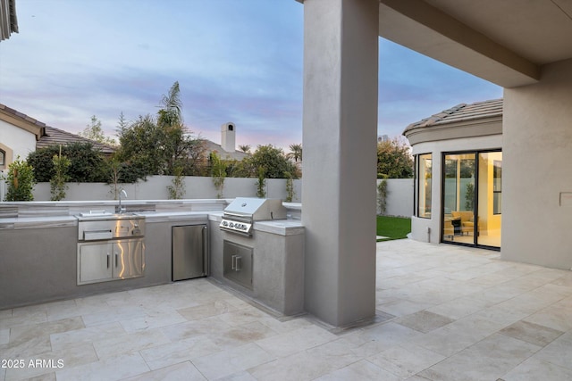 patio terrace at dusk with area for grilling