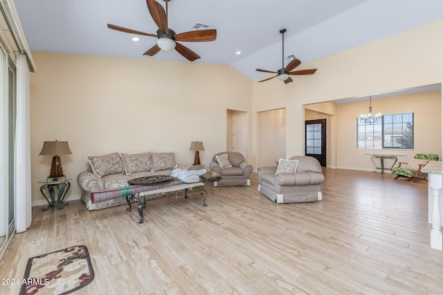 living room with light hardwood / wood-style floors, high vaulted ceiling, and ceiling fan with notable chandelier