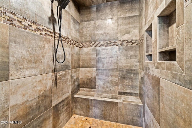 bathroom with a tile shower