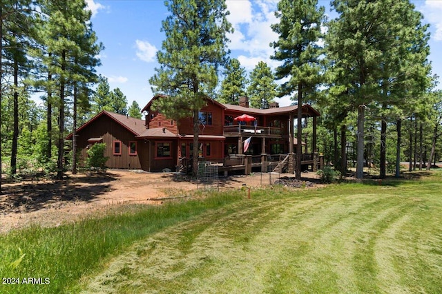 rear view of property with a lawn