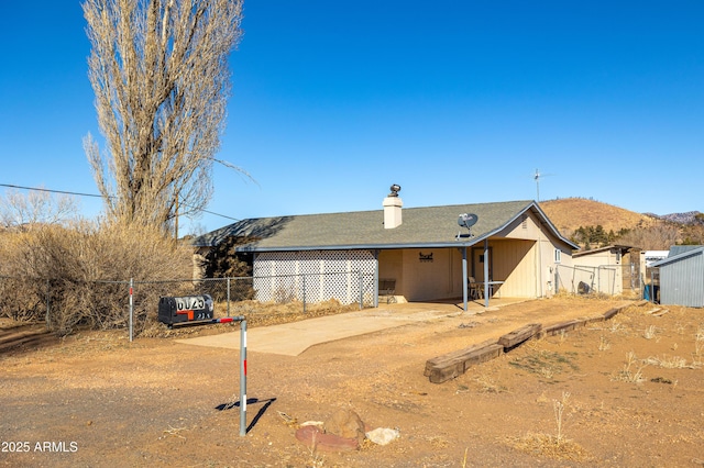 rear view of property with a mountain view