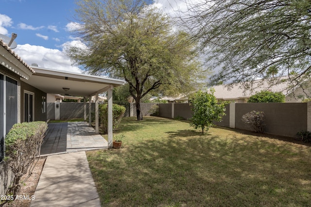 view of yard with ceiling fan, a patio, and a fenced backyard