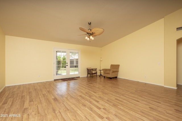 unfurnished room with baseboards, light wood-style floors, ceiling fan, and vaulted ceiling