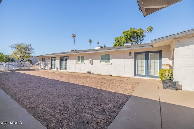 back of property with french doors and a patio area