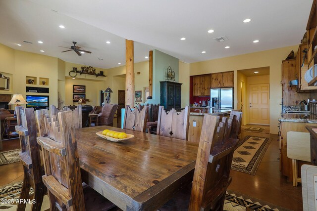 dining area featuring built in shelves and ceiling fan