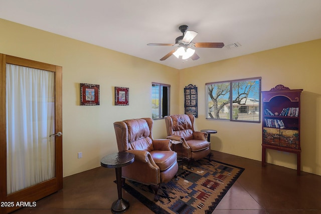 living area featuring tile patterned flooring and ceiling fan