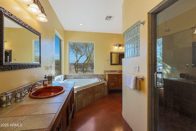 bathroom featuring separate shower and tub and vanity