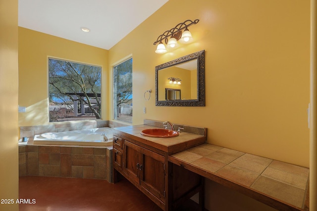 bathroom with tiled bath and vanity