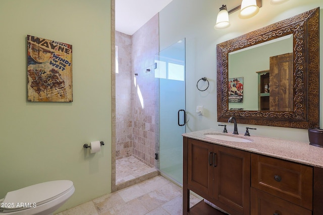 bathroom with toilet, vanity, and walk in shower