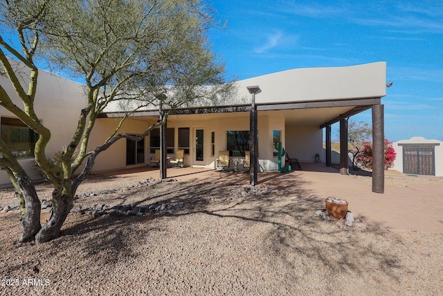 rear view of property featuring a patio area