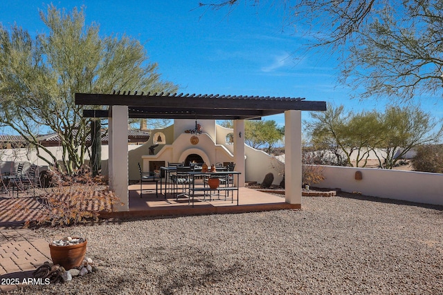 view of patio / terrace featuring exterior fireplace