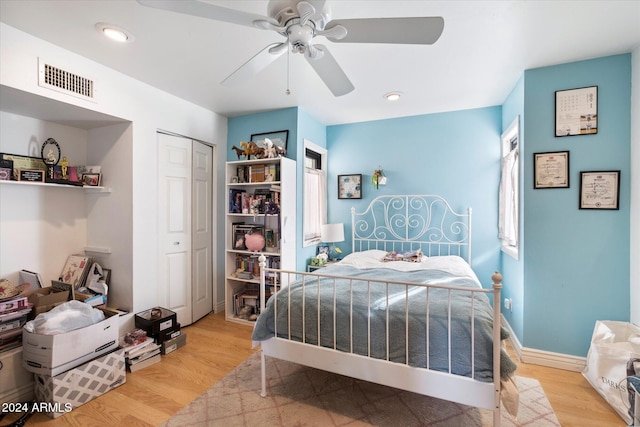 bedroom featuring ceiling fan, a closet, and light wood-type flooring