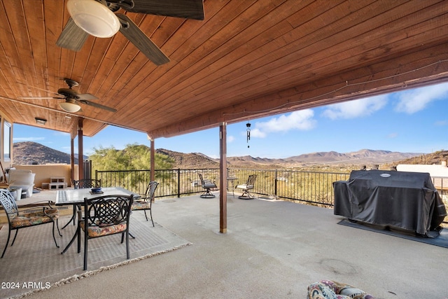 view of patio with a mountain view, ceiling fan, and grilling area