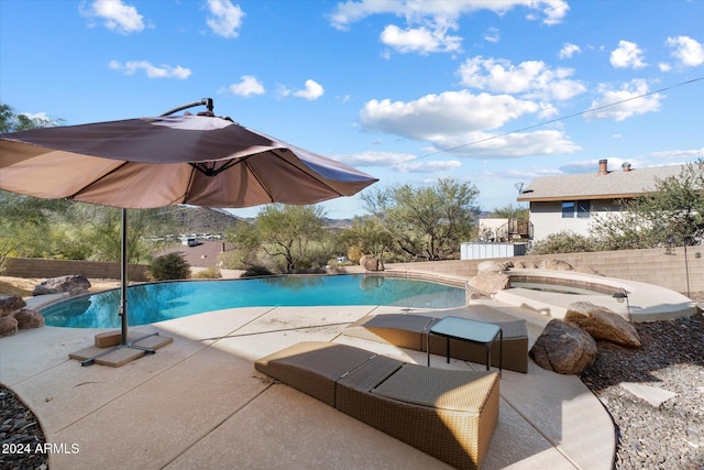 view of pool featuring a patio and a hot tub