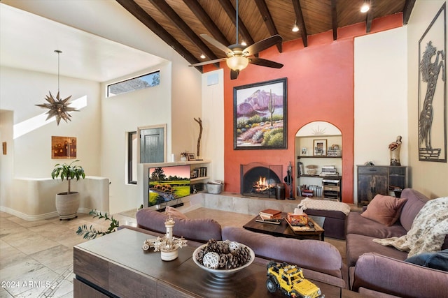 living room featuring ceiling fan, wooden ceiling, a fireplace, and high vaulted ceiling