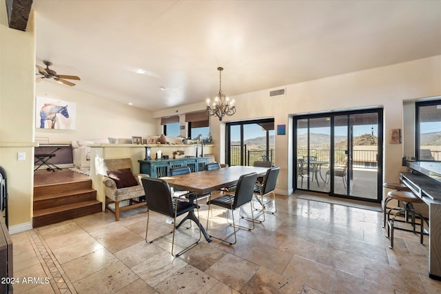 dining area featuring a wealth of natural light and ceiling fan with notable chandelier