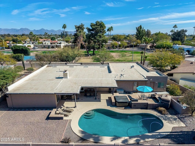 view of swimming pool featuring a patio area and a mountain view