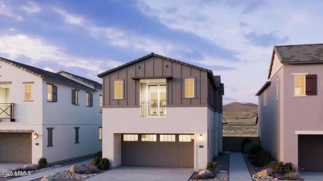 2455 W Rowel Rd, Phoenix, AZ 85085 - view of front of property with an attached garage, stucco siding, board and batten siding, a balcony, and driveway