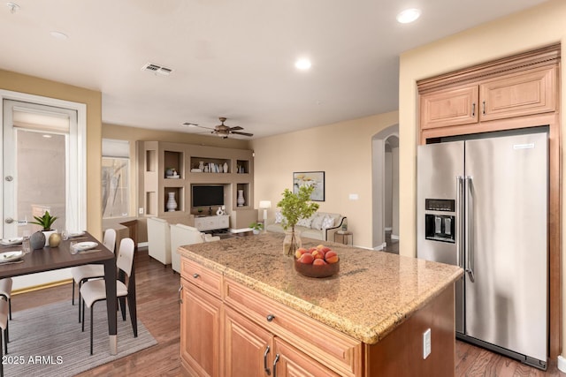 22063 N 77th St, Scottsdale, AZ 85255 - kitchen with stainless steel fridge with ice dispenser, arched walkways, a kitchen island, wood finished floors, and a ceiling fan