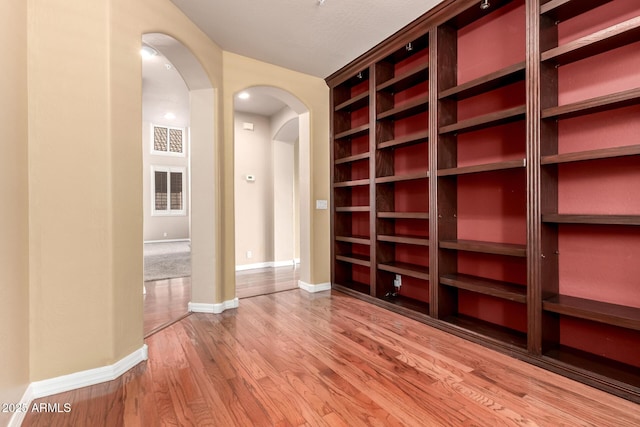 22063 N 77th St, Scottsdale, AZ 85255 - spare room with arched walkways, wood finished floors, and baseboards