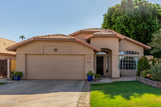 view of front of house with a front yard and a garage