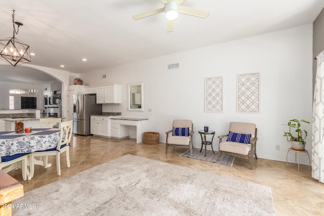 interior space with ceiling fan with notable chandelier and light tile patterned floors