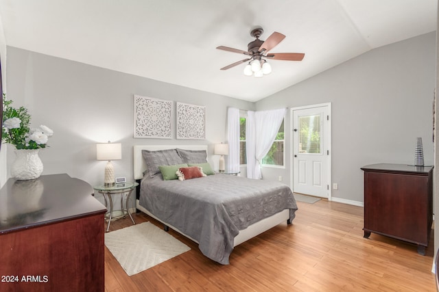 bedroom with light hardwood / wood-style floors, lofted ceiling, and ceiling fan